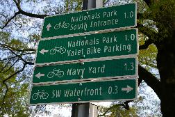 Bike route sign highlighting nearby destinations on 4th St SW.